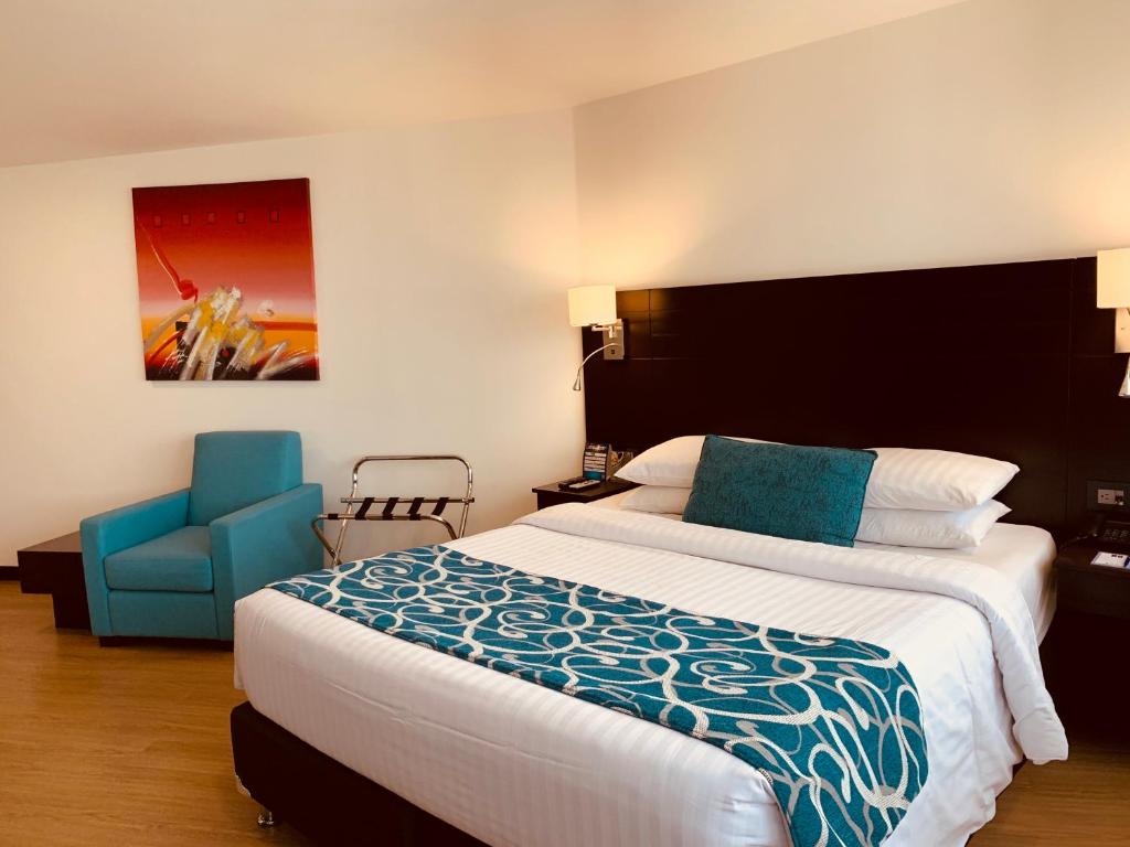 Postel nebo postele na pokoji v ubytování Hotel Dann Cali