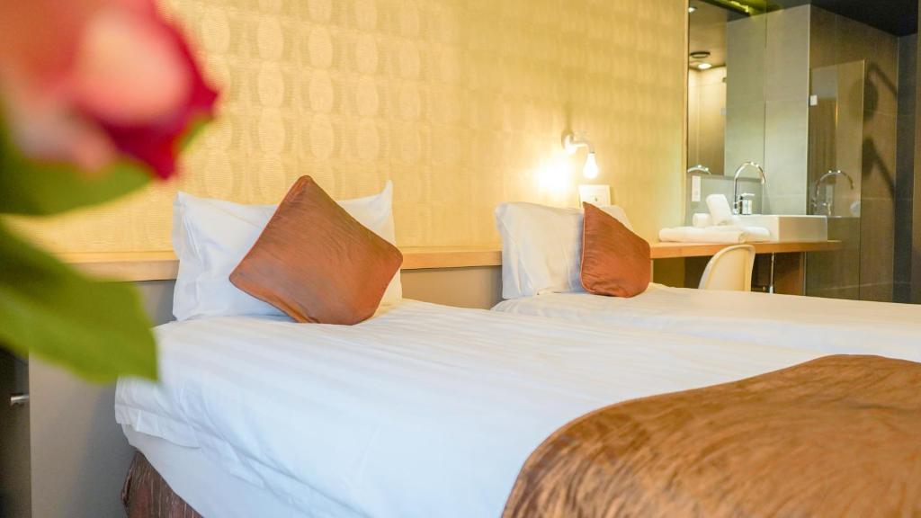 Postel nebo postele na pokoji v ubytování Amosa Liège City Centre Hotel