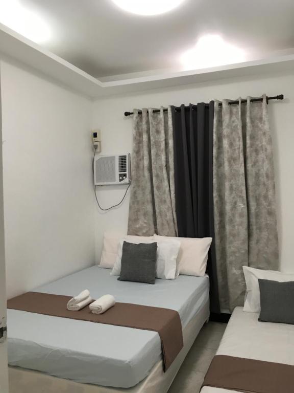 Postel nebo postele na pokoji v ubytování Bolinao Transient House B
