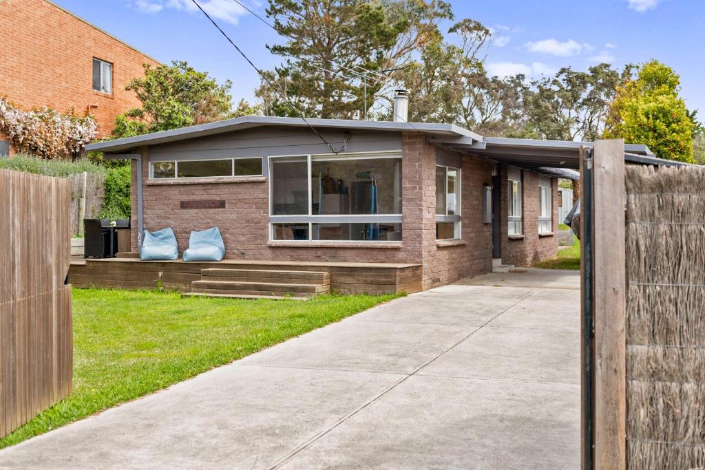 a brick house with a fence in front of it at Badenoch in Blairgowrie