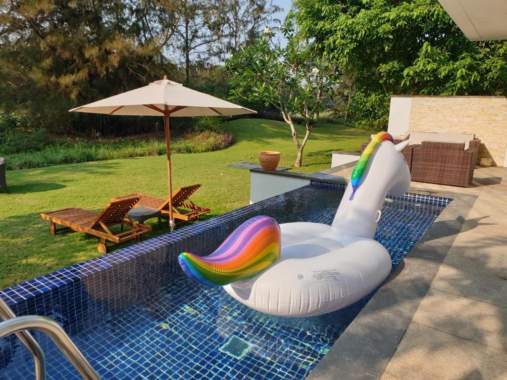 einen Pool mit einem aufblasbaren Schwan in einem Pool in der Unterkunft Villas Owner in The Ocean Resort Da Nang in Đà Nẵng