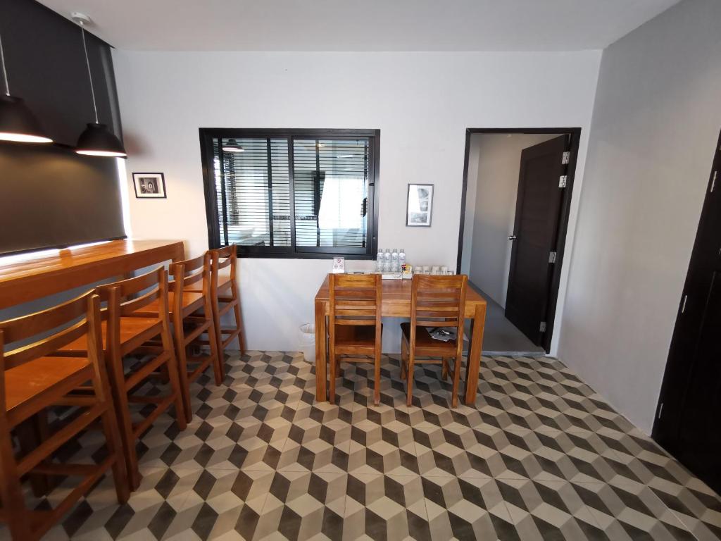 a dining room with a table and some chairs at The Besavana Phuket - SHA Extra Plus in Phuket Town