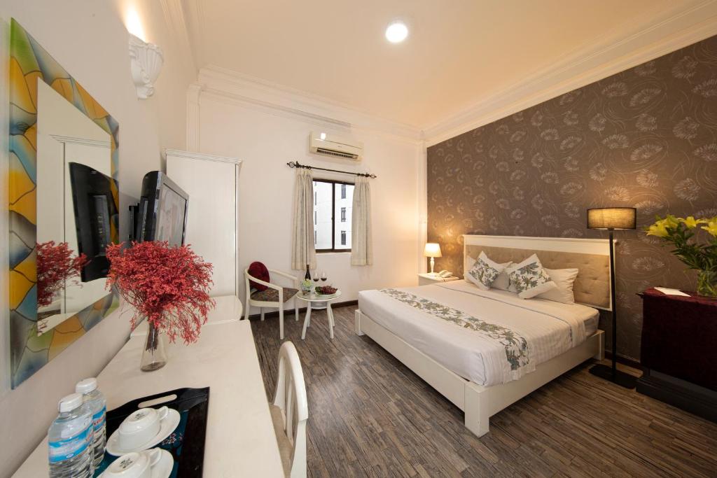 Giường trong phòng chung tại Vilion Central Hotel & Spa