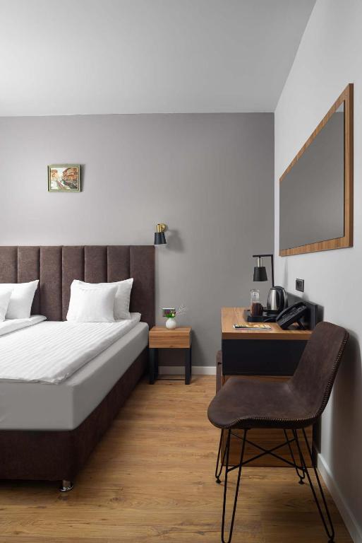 Postel nebo postele na pokoji v ubytování Labirint Boutique Hotel