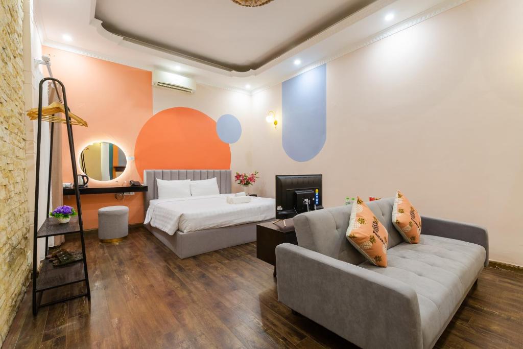 a living room with a couch and a bed at Ohana House in Hanoi