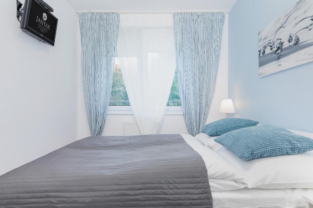 Posteľ alebo postele v izbe v ubytovaní Jantar Apartamenty- Zielone Tarasy