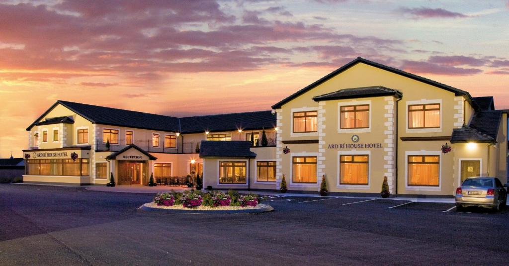 a building with a car parked in a parking lot at Ard Ri House Hotel in Tuam