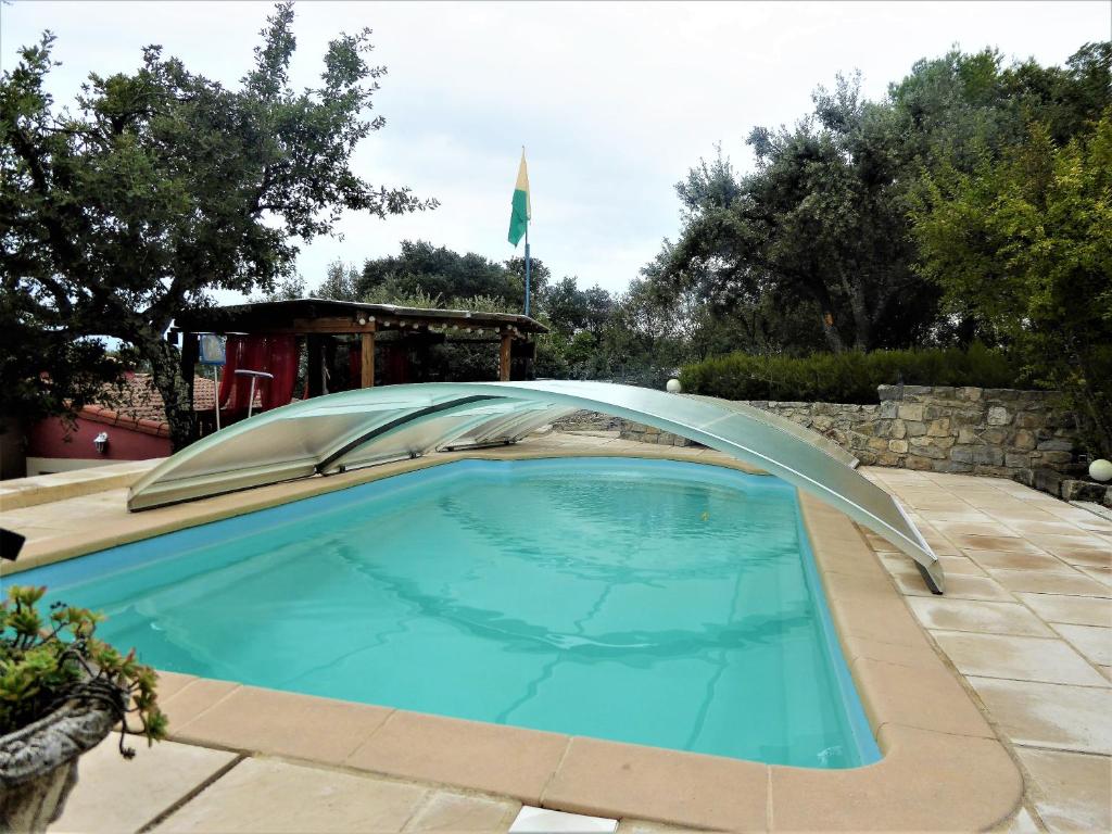 a swimming pool with a cover over it at Les Gîtes De Cayenne - Gîte ORIENT in Dions