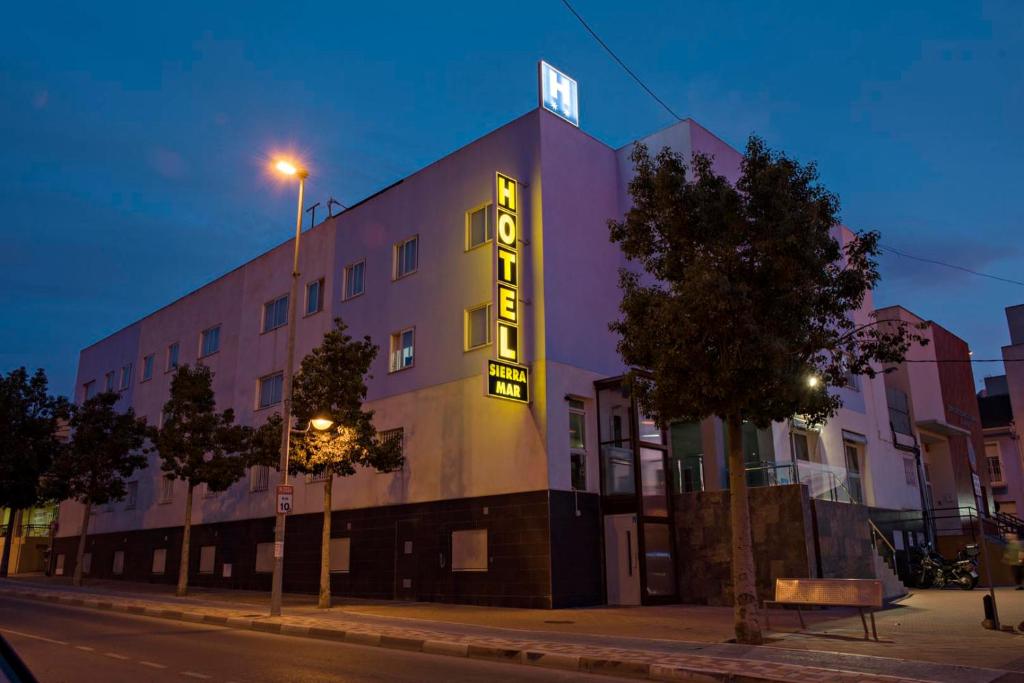 a building with a neon sign on the side of it at Hotel Sierra Mar in La Unión