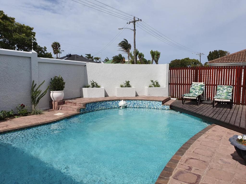 a swimming pool in a yard with a fence at Nahoon Bed & Breakfast in East London