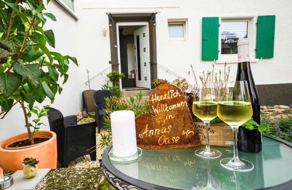 two glasses of white wine sitting on a glass table at Annas Oase in Meckenheim
