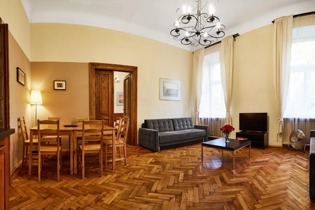 a living room with a table and a couch at Prestige location apartments Pijarska street in Krakow