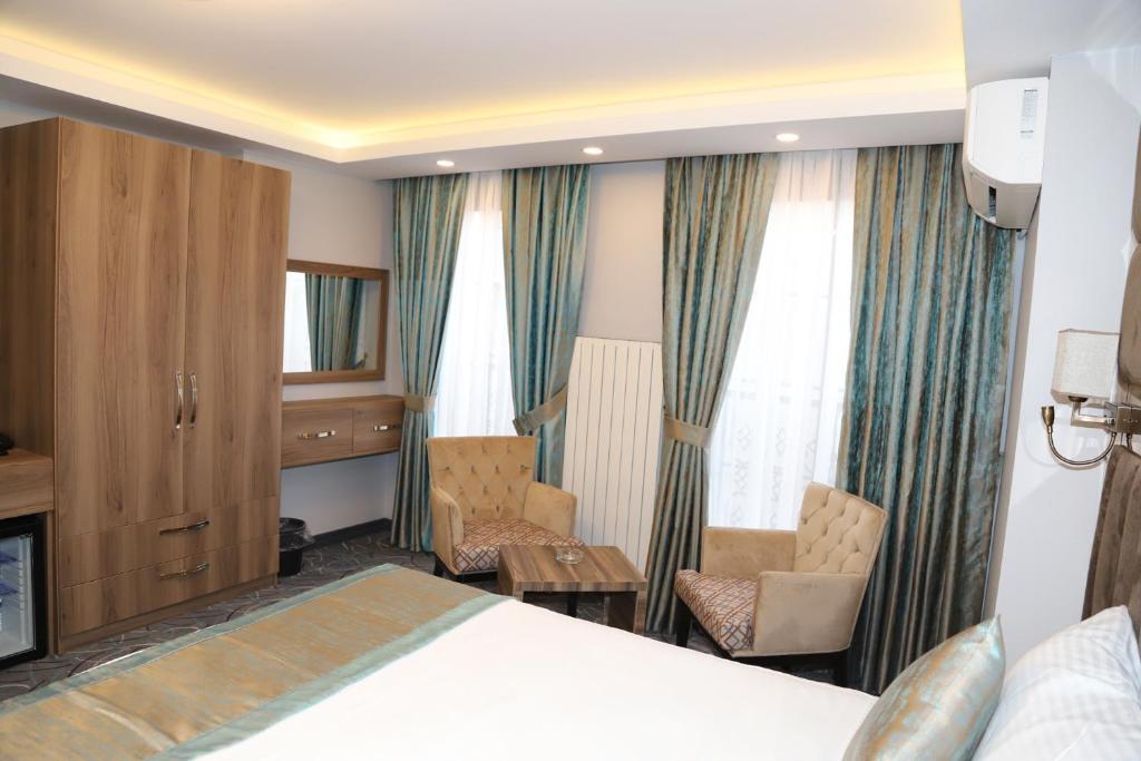 Postel nebo postele na pokoji v ubytování Grand Kavi Hotel