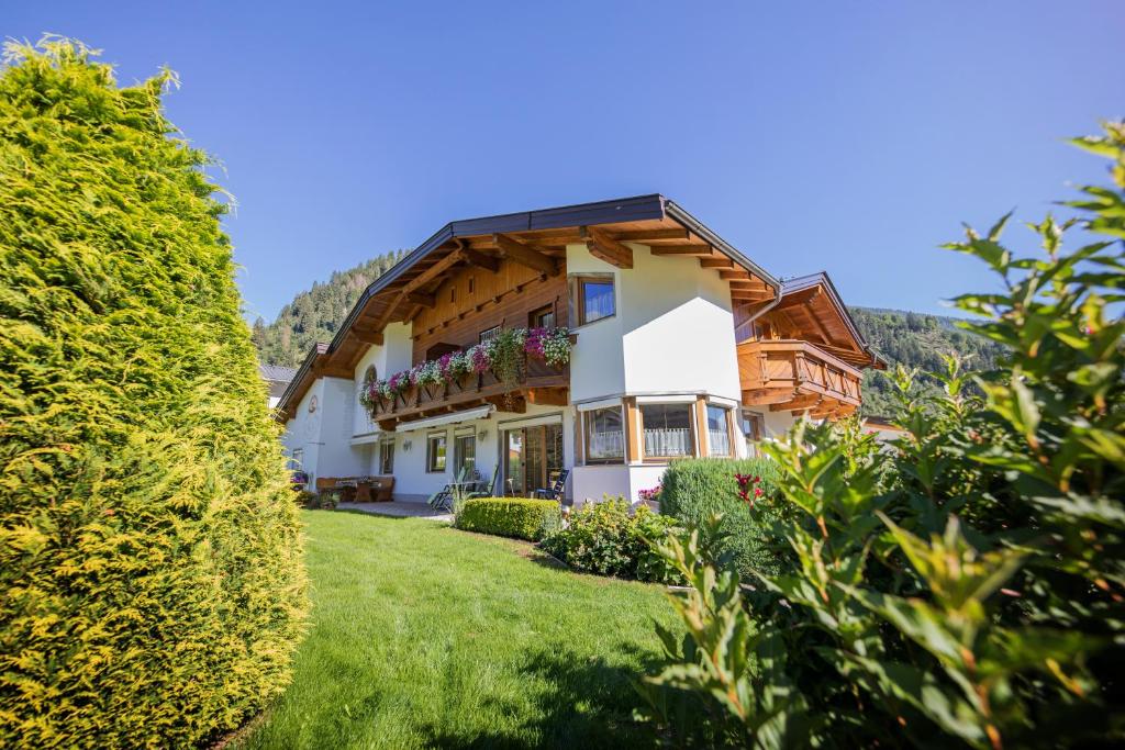 a house in the mountains with a green yard at Haus Egger in Neustift im Stubaital