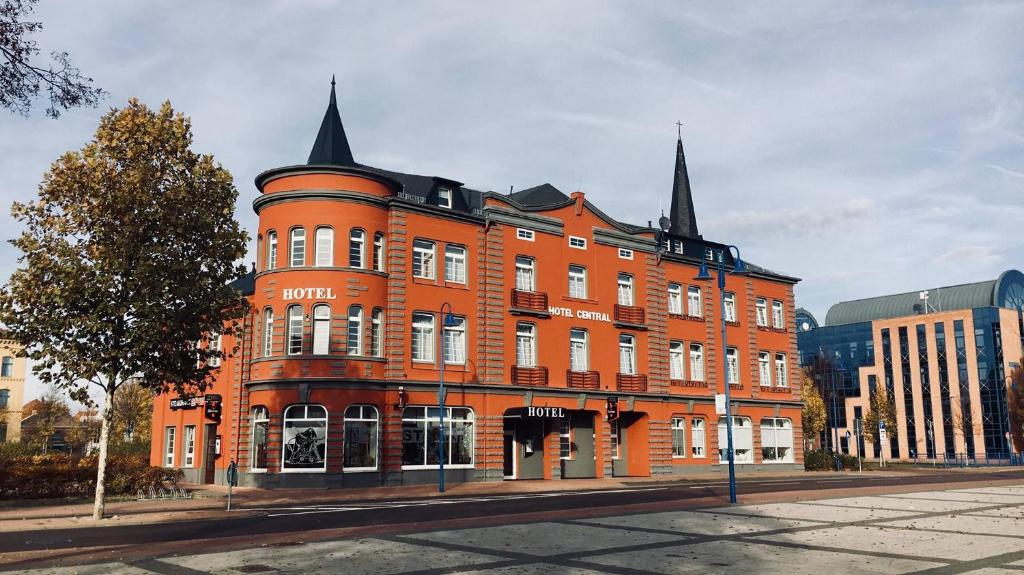 a large orange brick building on a city street at Hotel "Central" Inh Carolin Krause in Bitterfeld