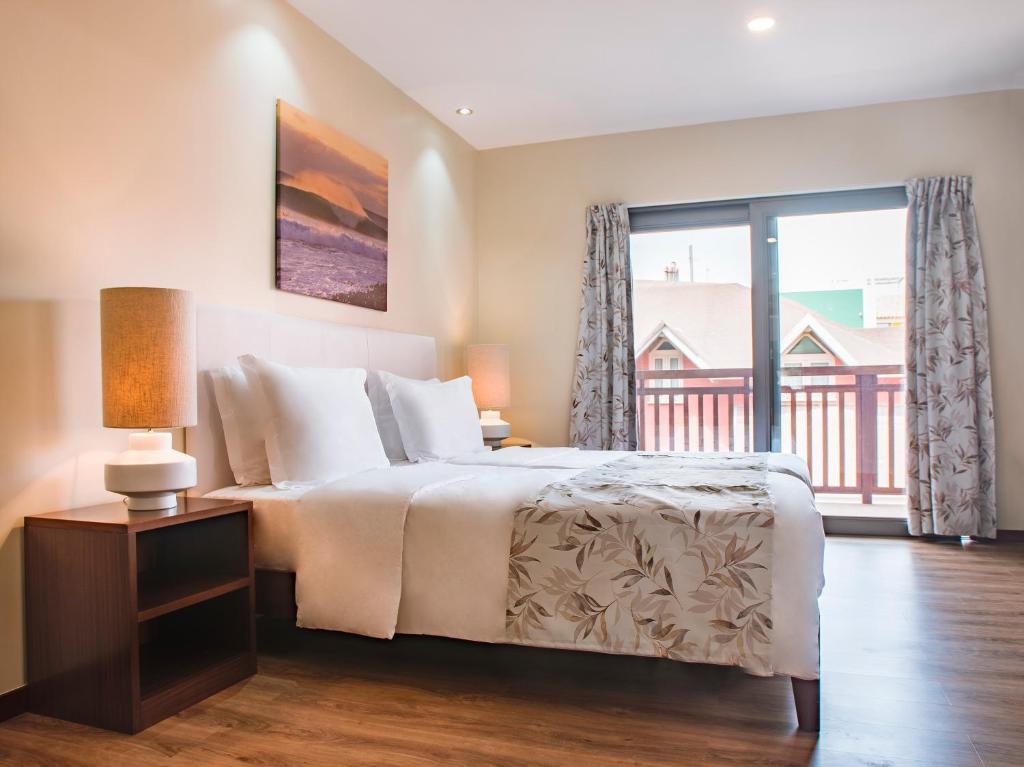 a bedroom with a bed and a large window at Angulo House in Santa Maria