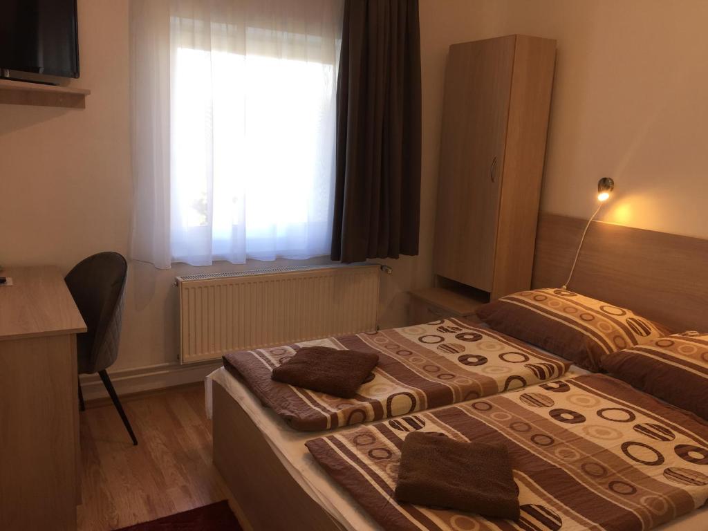 Postel nebo postele na pokoji v ubytování Gerendas Panzió