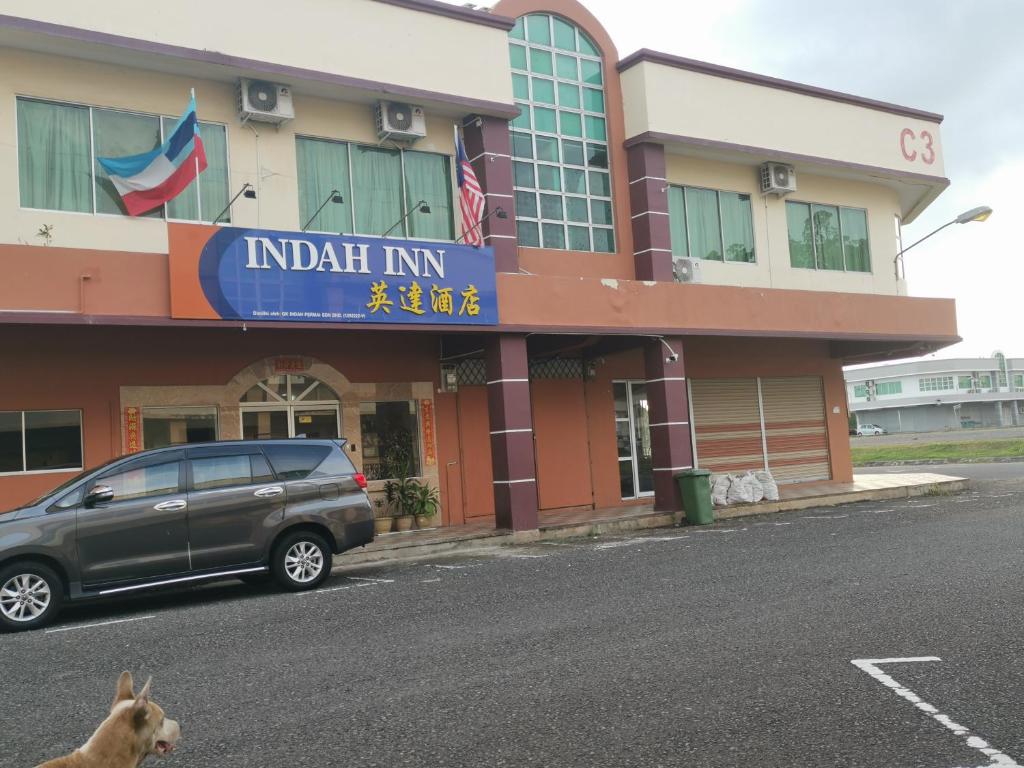 a car parked in front of a building at Indah Inn in Tawau