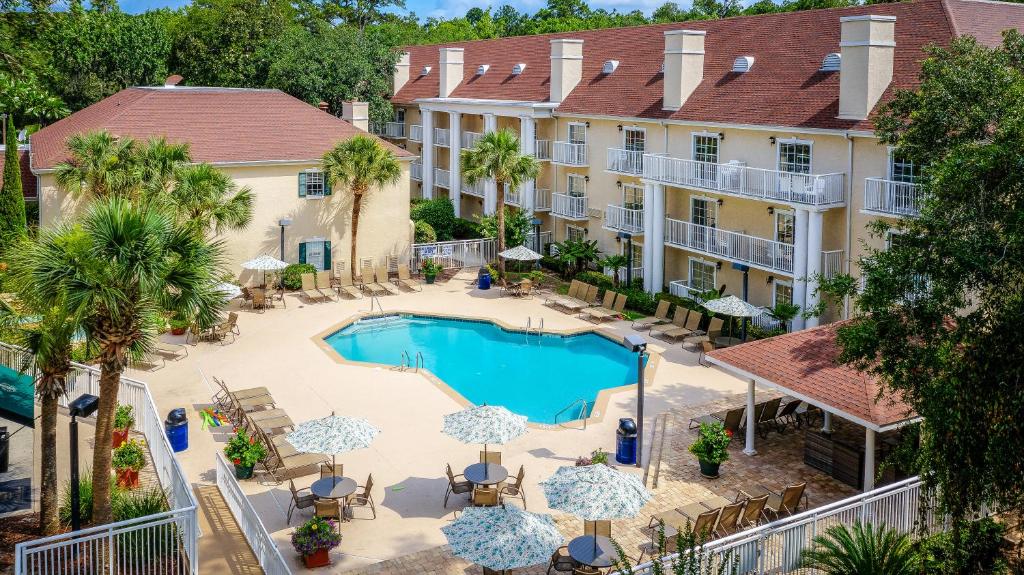 an aerial view of a hotel with a pool and patio furniture at Palmera Inn and Suites in Hilton Head Island