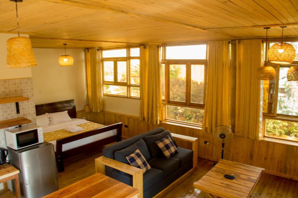 a living room with a couch and a table at Nile Front Cottages in Jinja