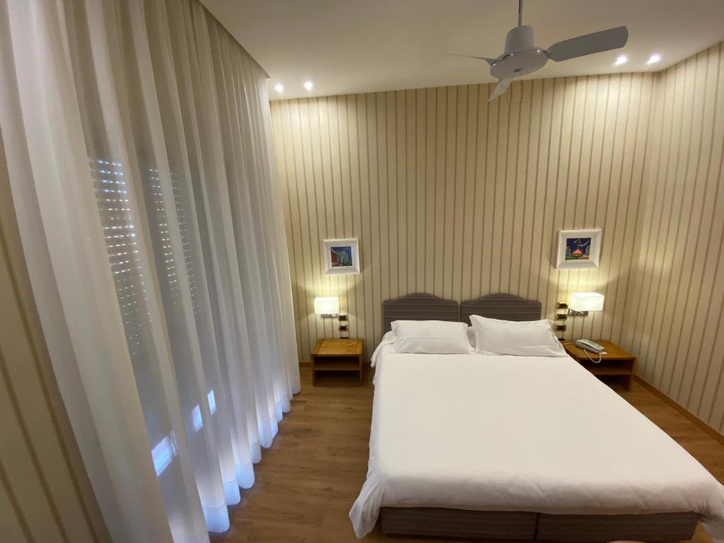 Postel nebo postele na pokoji v ubytování Hotel Cicolella