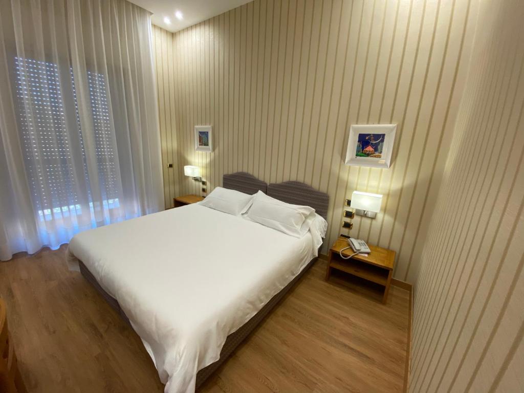 Postel nebo postele na pokoji v ubytování Hotel Cicolella