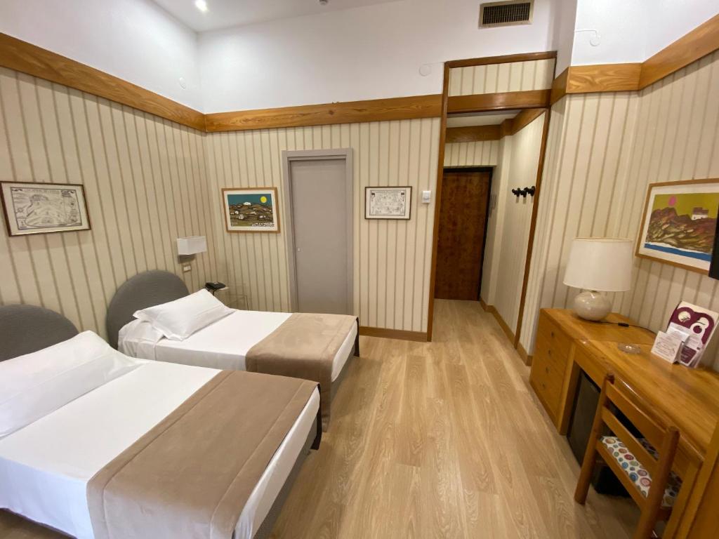Postel nebo postele na pokoji v ubytování Hotel Cicolella