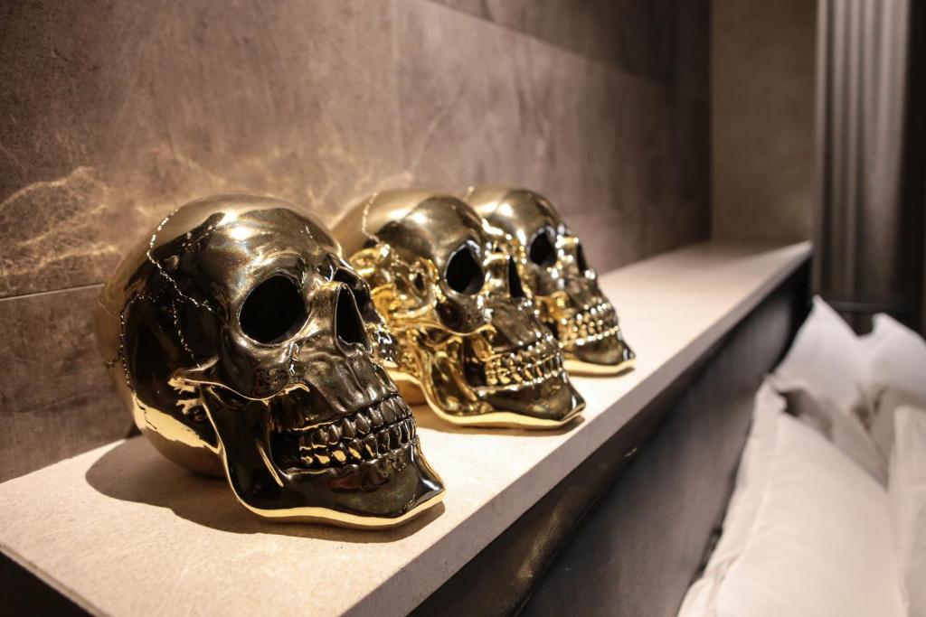 two skulls sitting on a shelf in a room at Neko Boutique Hotel in Cagliari