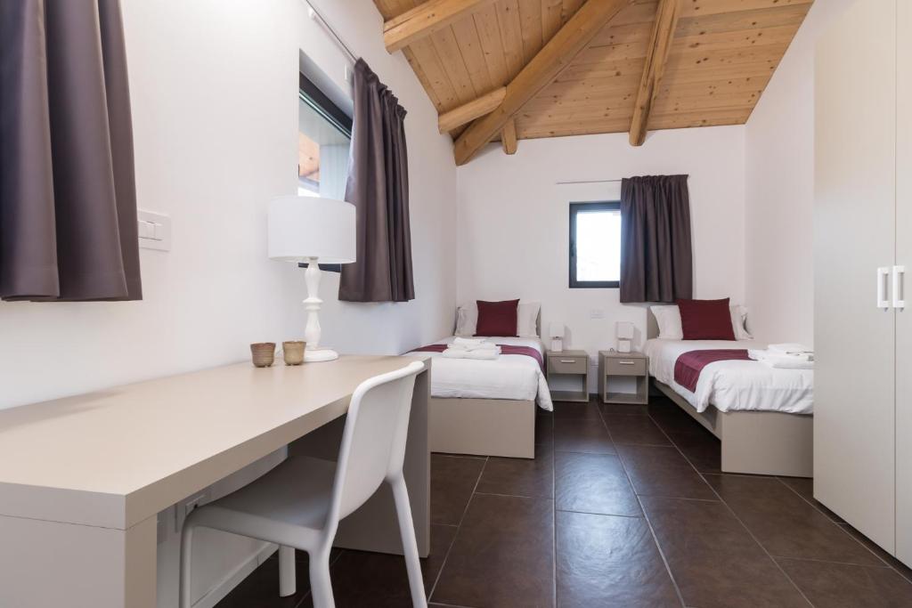 Postel nebo postele na pokoji v ubytování Hotel Cascina Fossata & Residence