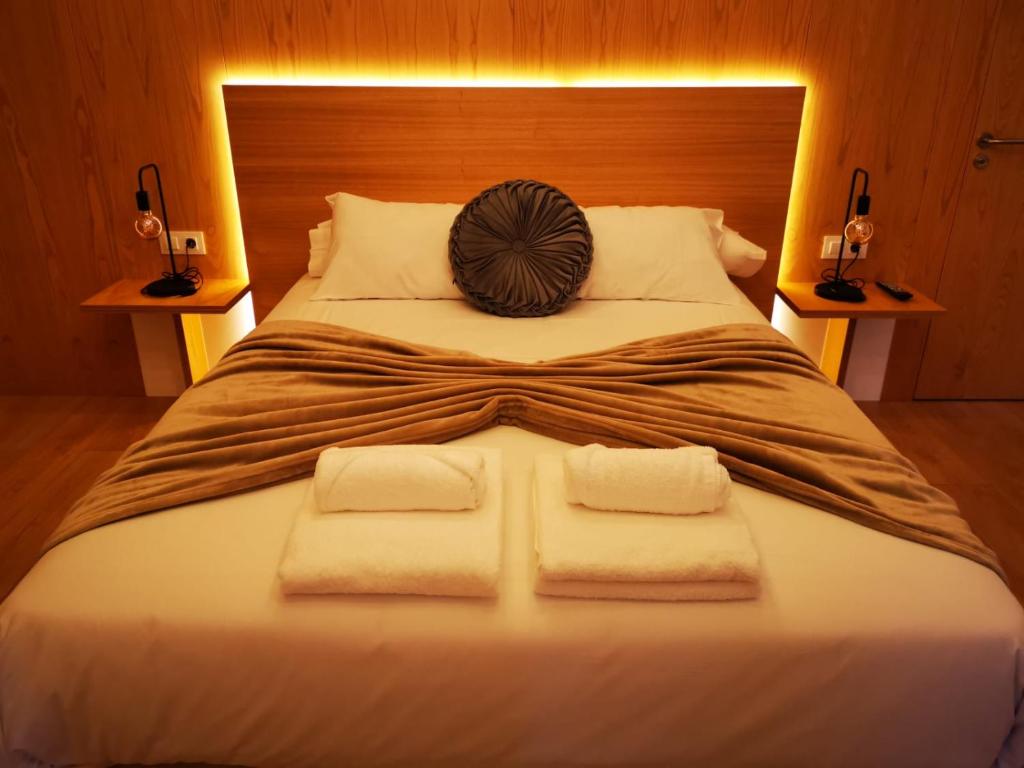 a bedroom with a large bed with towels on it at A Casa da Botica in Samos