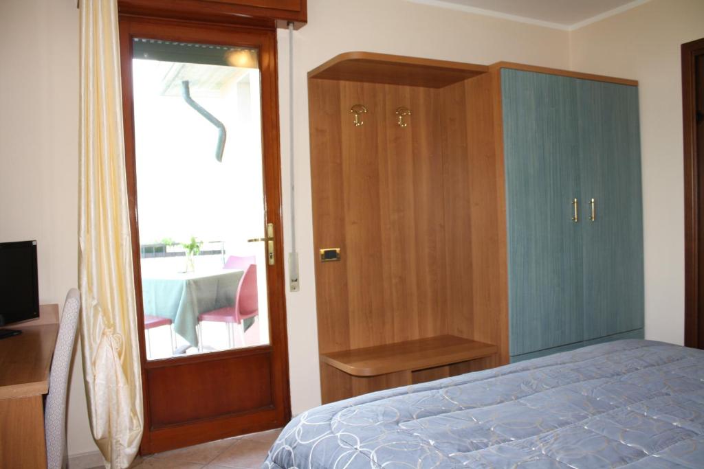 Postel nebo postele na pokoji v ubytování Albergo Ristorante Punta Dell'Est