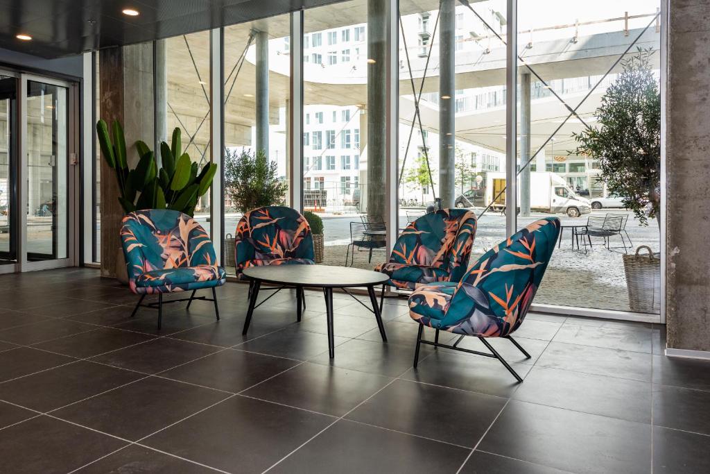 a group of chairs and a table in a lobby at Cabinn Copenhagen in Copenhagen