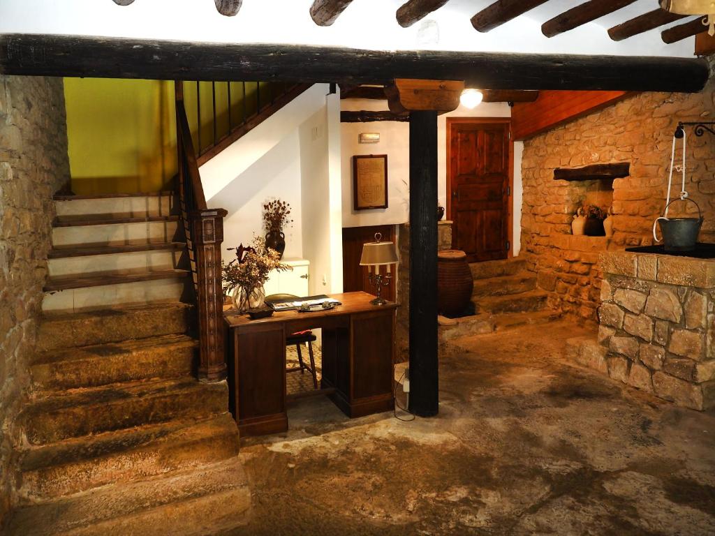 a room with a desk and stairs in a building at Casa Torralba in El Frago