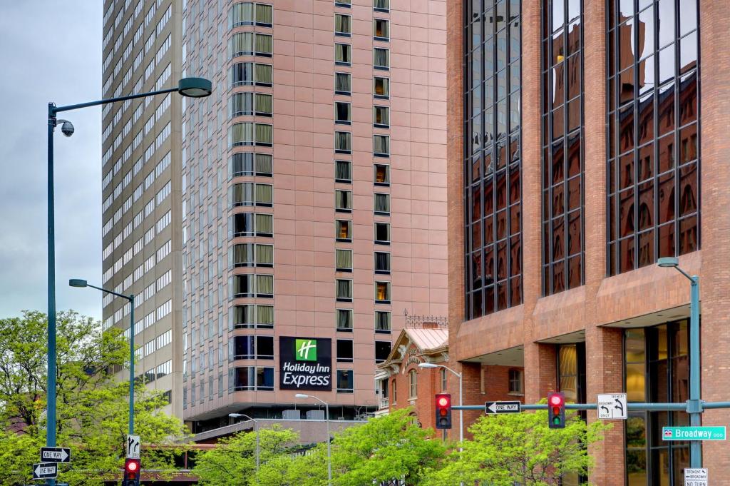a tall pink building with a sign in front of it at Holiday Inn Express Denver Downtown, an IHG Hotel in Denver