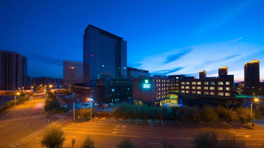 a city skyline at night with buildings and street lights at Holiday Inn Express Ordos Dongsheng by IHG in Ordos