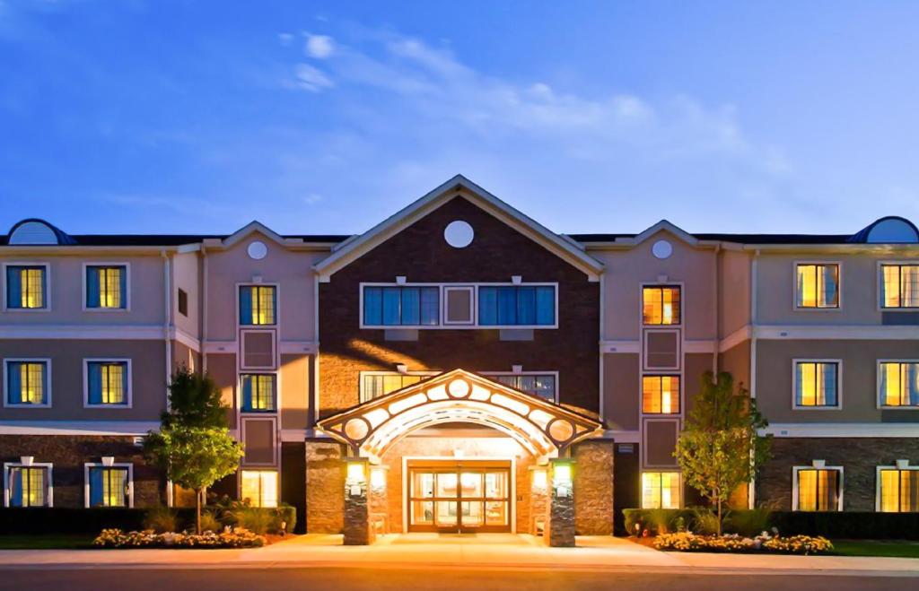 a large apartment building at night at Staybridge Suites Detroit-Novi, an IHG Hotel in Novi