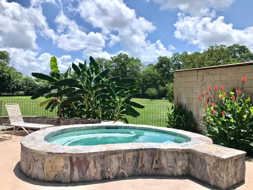 a small pool in a stone circle in a yard at Waterwheel Retreat in New Braunfels