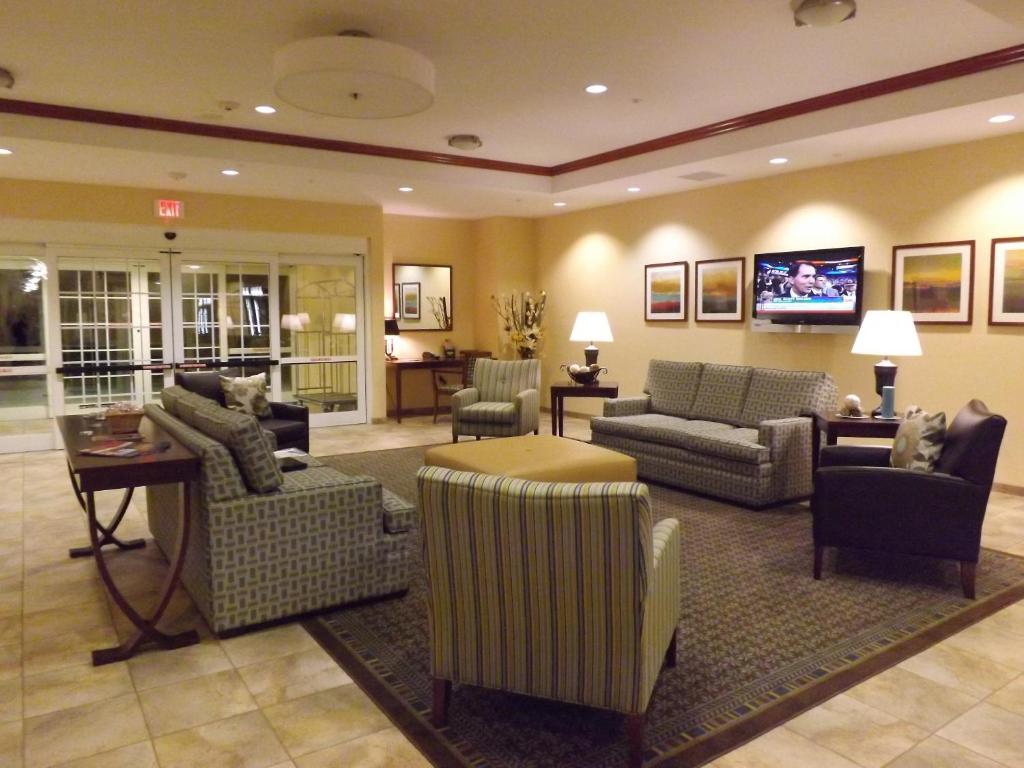 a large living room with couches and a tv at Candlewood Suites Fredericksburg, an IHG Hotel in Fredericksburg