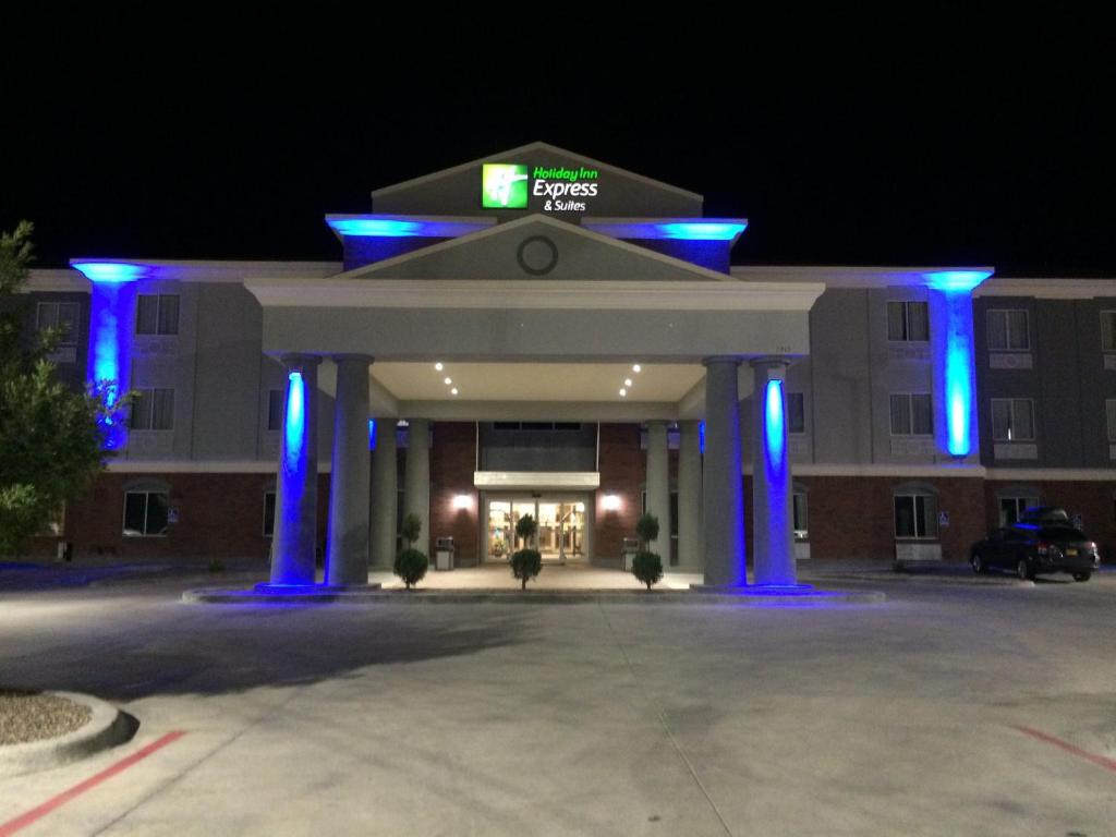 a large building with blue lights in front of it at Holiday Inn Express Hotel and Suites Fort Stockton, an IHG Hotel in Fort Stockton
