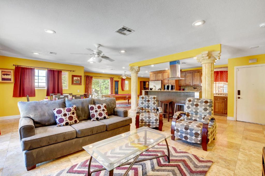 a living room with a couch and a table at Las Vegas Elegance! Pool Table & Sparkling Pool! Home in Las Vegas