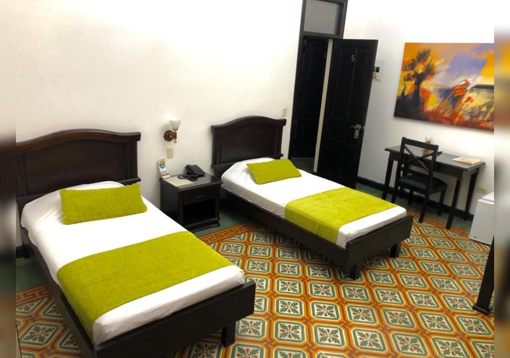 Postel nebo postele na pokoji v ubytování Casa Escobar Buga