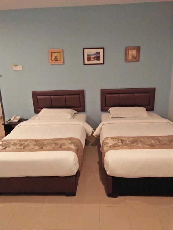Postel nebo postele na pokoji v ubytování TIONG HUA HOTEL