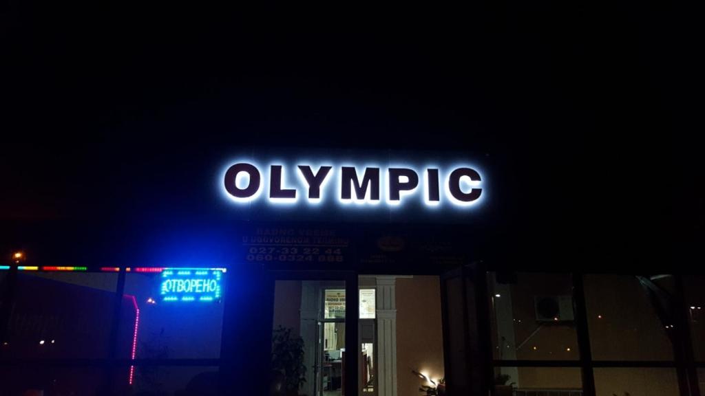 a neon olympic sign on top of a building at Olympic Residence Hotel in Prokuplje