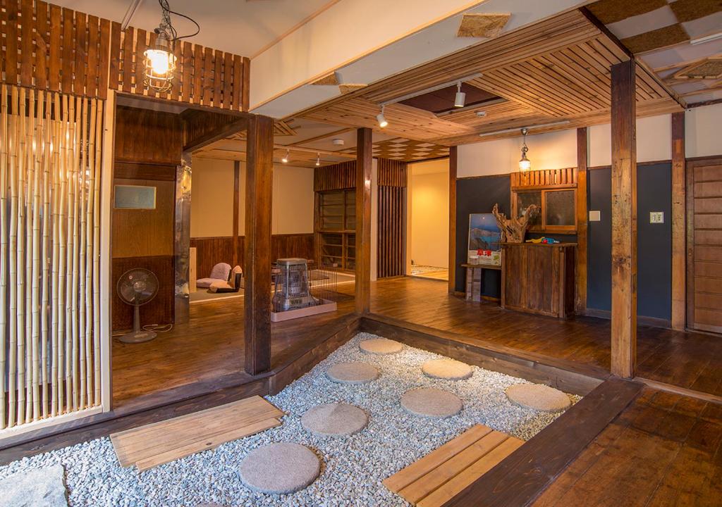 a living room filled with furniture and a large window at Kusatsu Onsen Eidaya in Kusatsu