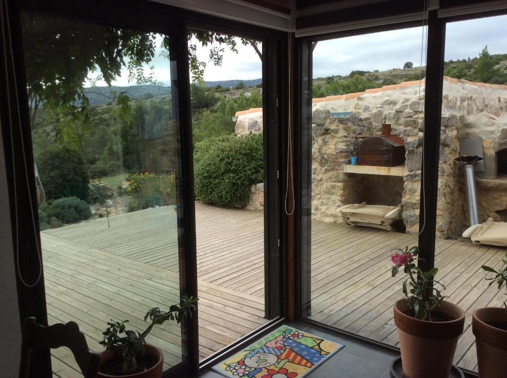 a room with a sliding glass door looking out onto a deck at Domaine Castelsec in Roquefort-des-Corbières