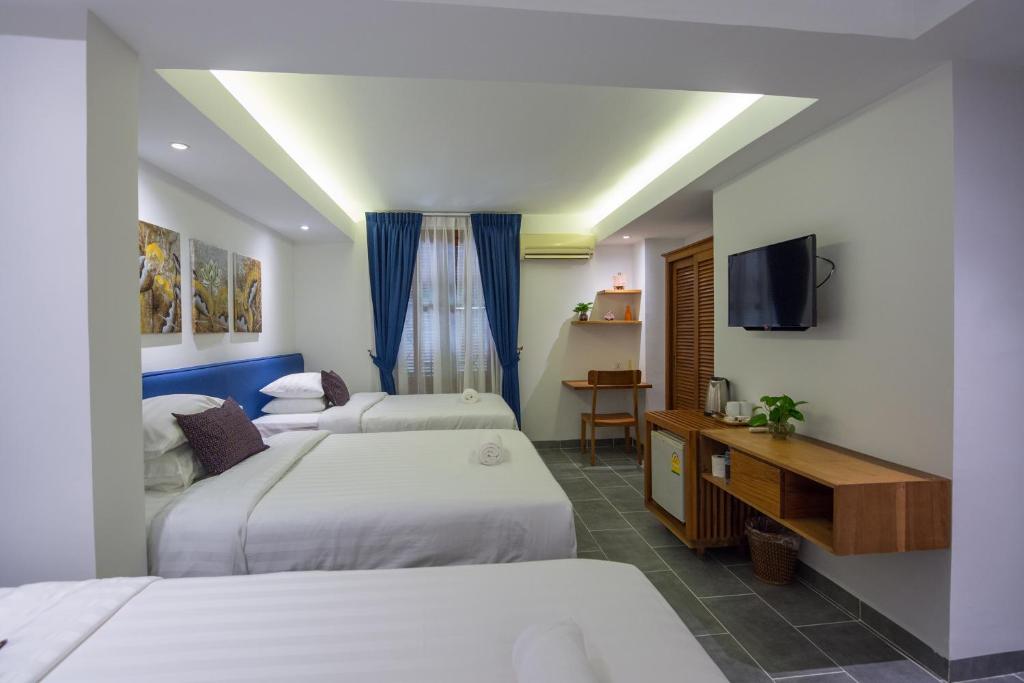 Postel nebo postele na pokoji v ubytování Neth Socheata Hotel