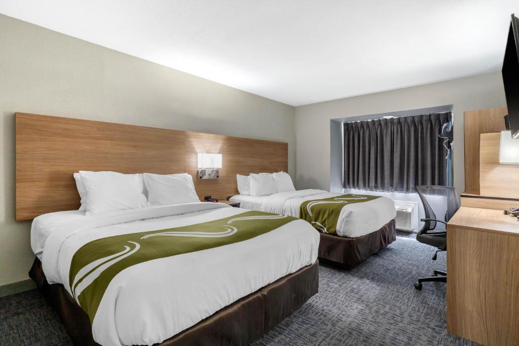 a hotel room with two beds and a television at Quality Inn Downtown - near Market Square in San Antonio