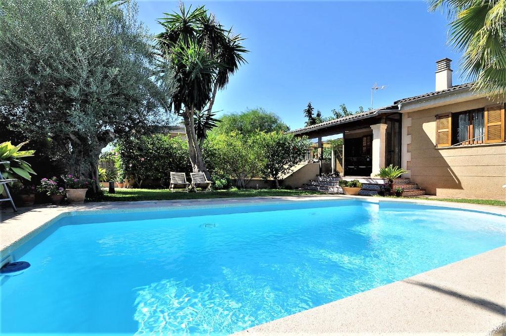 a large blue swimming pool in front of a house at "PEP POMAR" Chalet en Palma de Mallorca in Palma de Mallorca