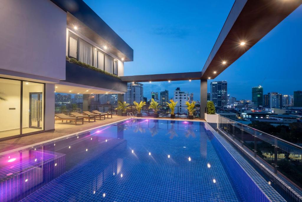 a swimming pool on the roof of a building with a city skyline at Residence 105 Hotel and Apartment in Phnom Penh