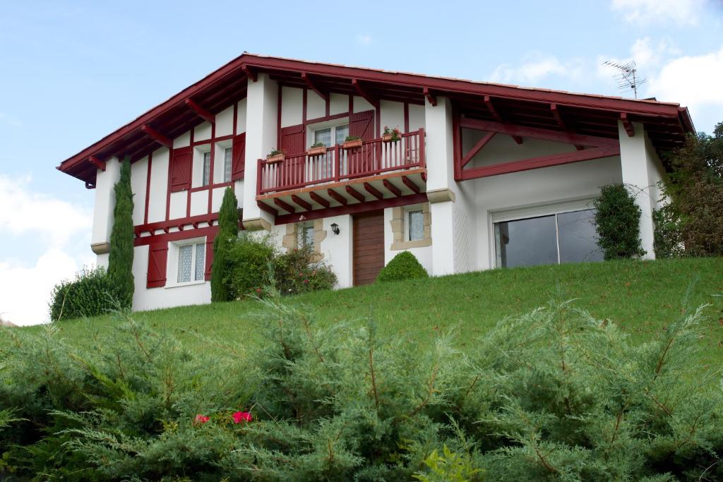 a house on top of a grassy hill at Chambres d'Hôtes Garicoitz in Saint-Jean-Pied-de-Port